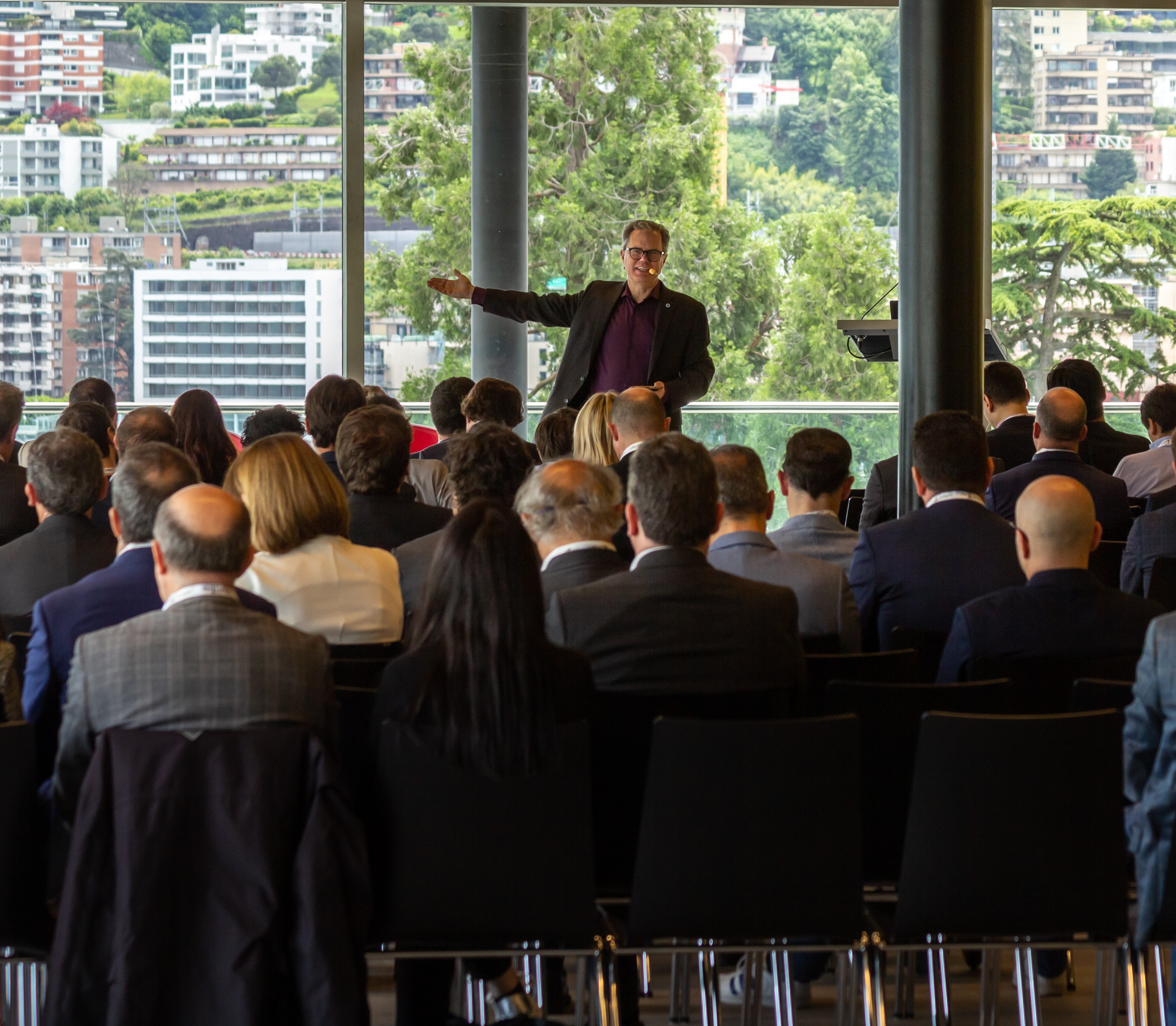 Thomas Cox speaking to a gathering of investors in Lugano, Switzerland.