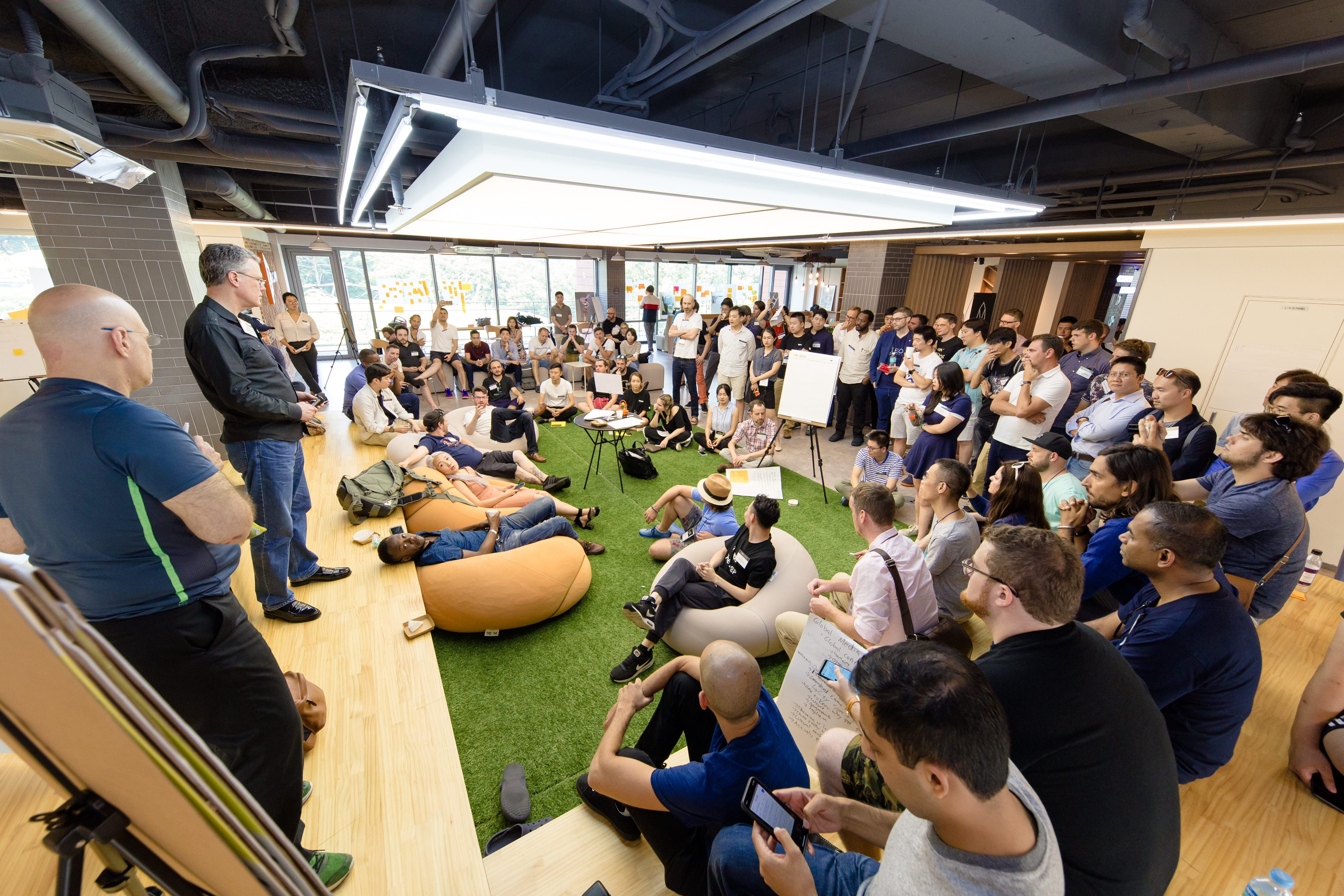 Thomas Cox leads the whole-group debrief at an unconference in Seoul, South Korea.